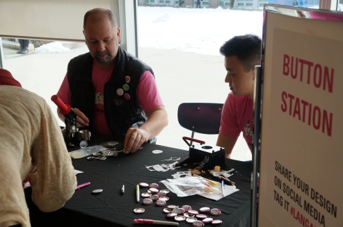 Ed Hensley, Secretary to Council of the Langara Student Union, helps make buttons at Langara’s Pink shirt day.